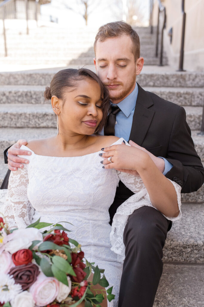 Bride and groom sit on steps during their Indianapolis elopement.