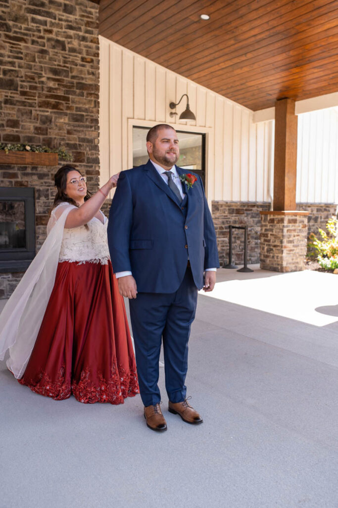 Bride taps groom's shoulder to turn around for first look.