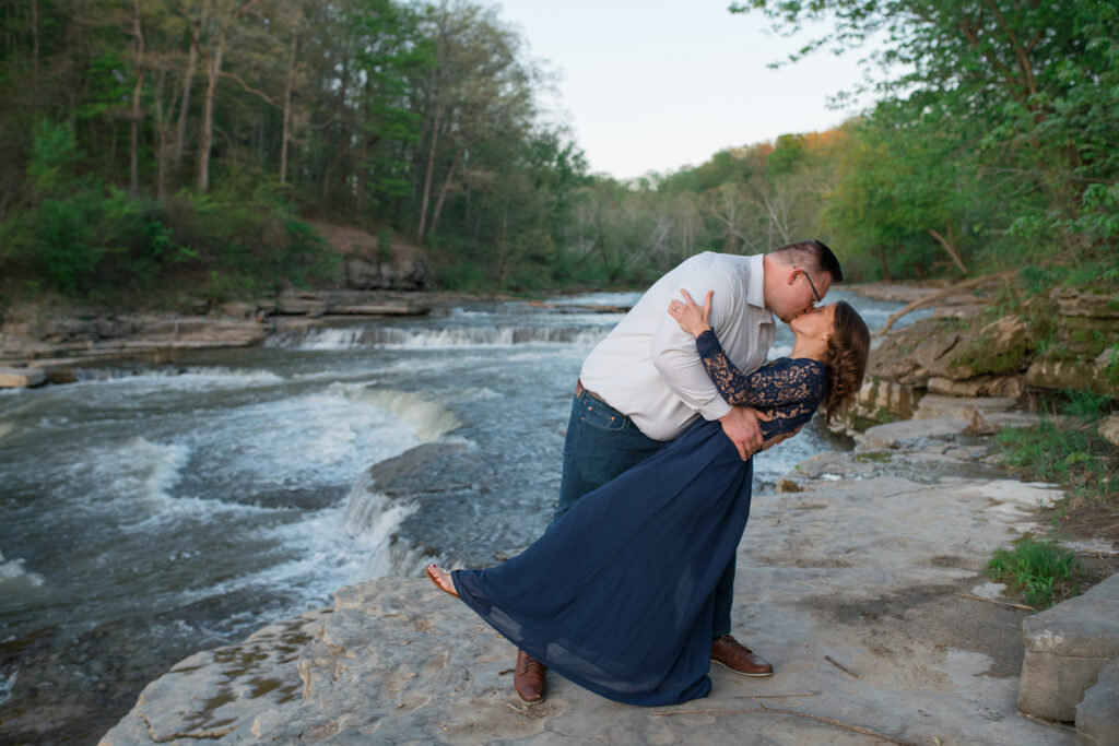 Engaged couple kisses after getting engaged at Cataract Falls.