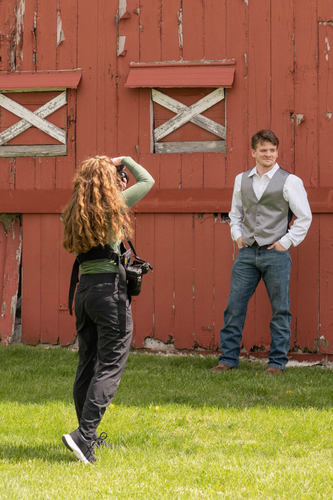 Wedding photo and video team taking a photo of a groom on his wedding day.