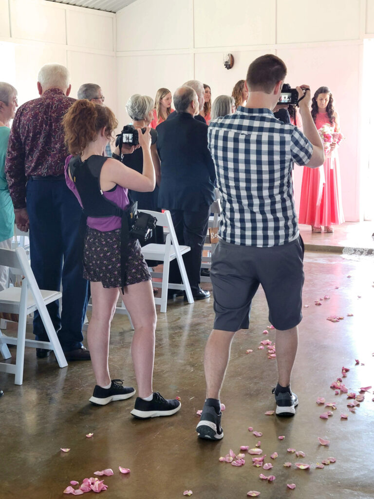 Wedding photo and video team document a wedding ceremony.