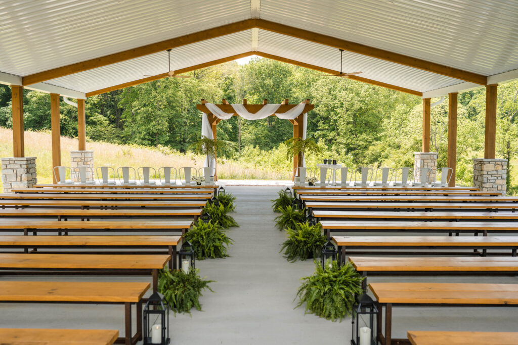 In addition to a large white building for an indoor reception, The Wilds Wedding Venue also has a covered outdoor ceremony space.