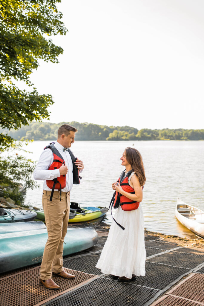 Groom and bride put on red life vests before getting into canoe at Eagle Creek Park.