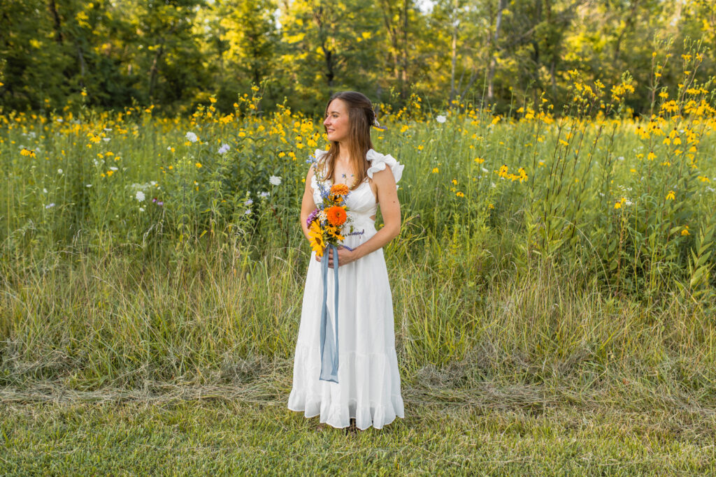 Bride holds a bouquet of wildflowers at her wildflower elopement.