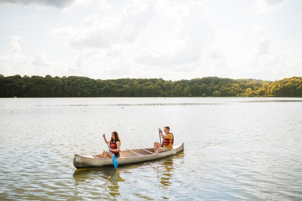 Couple paddling in canoes at Eagle Creek Park in Indianapolis.