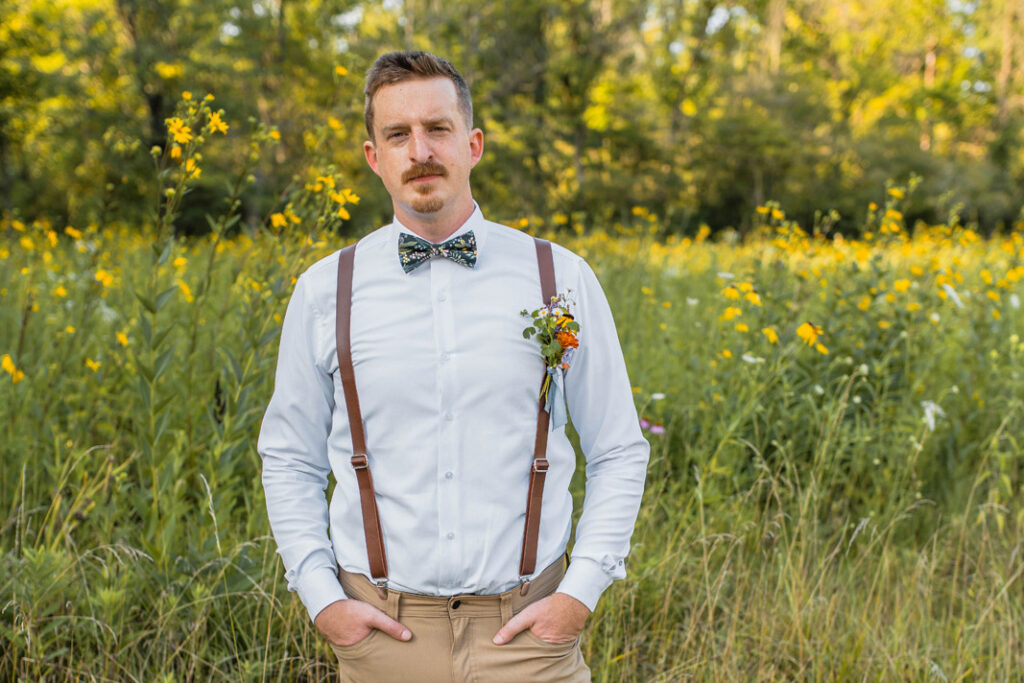 Groom wears a wildflower bowtie at wildflower elopement.