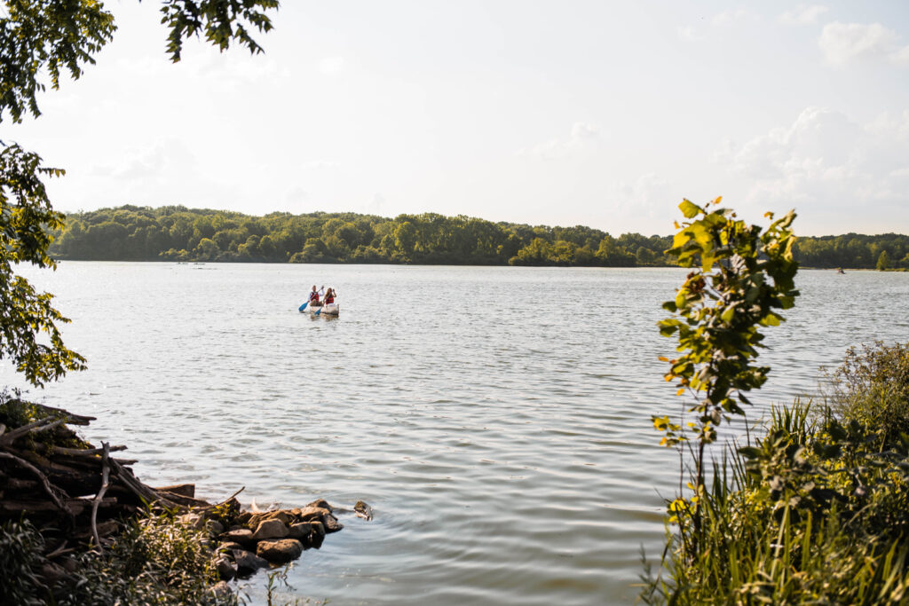 Bride and groom enjoy a sunny canoe ride at Eagle Creek Park.