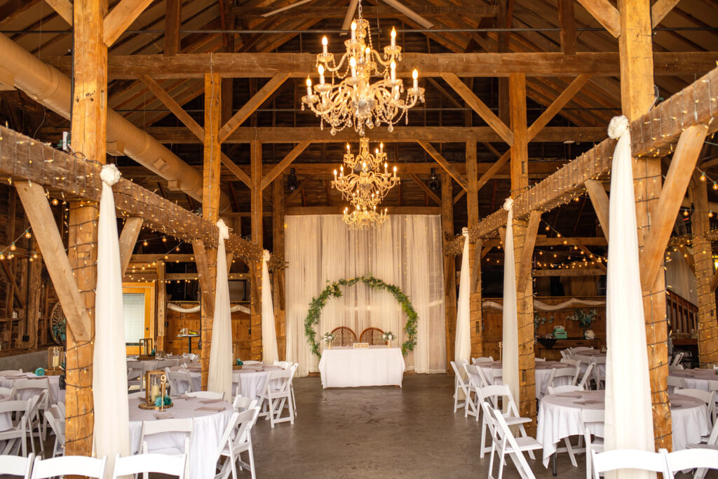 Barn with chandeliers and twinkle lights at Ash and Oak Weddings.