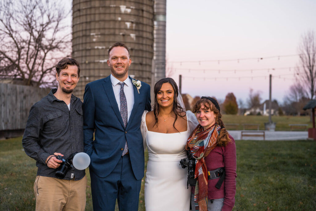 Bride and groom take a photo with their wedding photographers, Vallosio Photo + Film, at Ash and Oak Weddings.