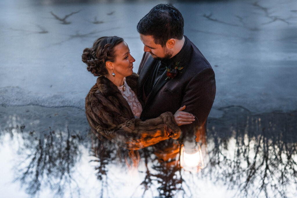 Double exposure of bride and groom by the frozen lake for their wedding at The Conservatory at Evergreen.