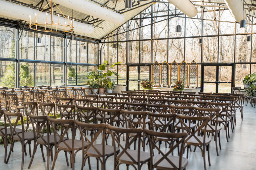 Indoor ceremony space with sun coming in through glass windows at The Conservatory at Evergreen.