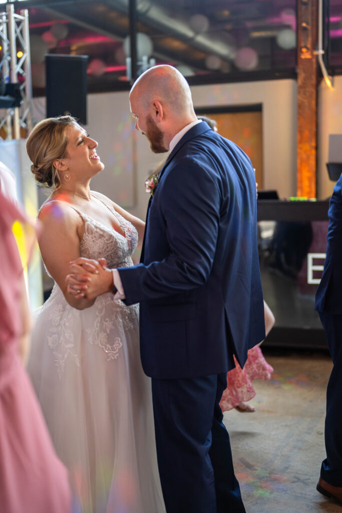 Bride and groom dance together at wedding reception at One World at Woolery Mill