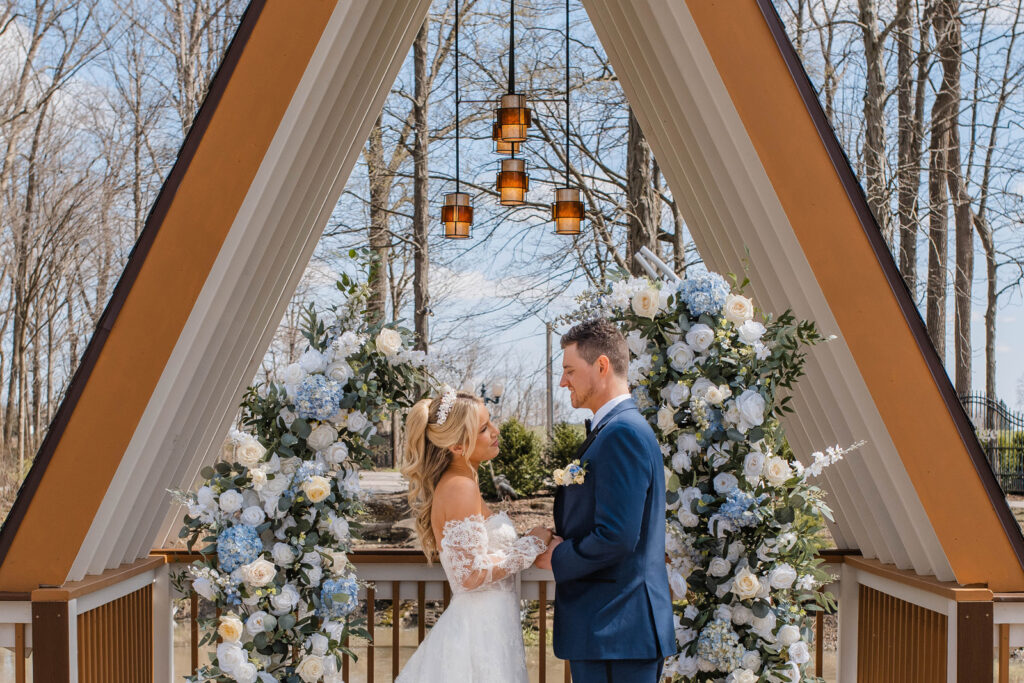 Couple looks at one another during outdoor ceremony at Lizton Lodge Wedding Venue.