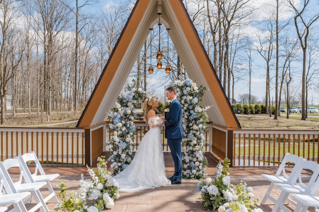 Bride and groom share vows during outdoor ceremony.