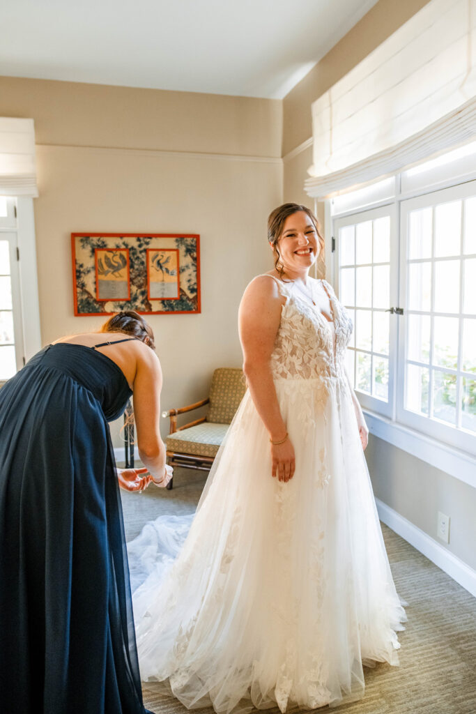 Bride gets into her wedding dress.