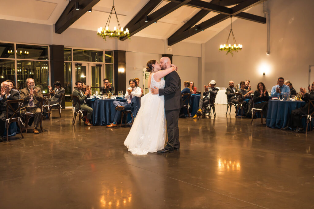 Couple shares first dance in front of all their guests at The Bluffs at Conner Prairie wedding venue.