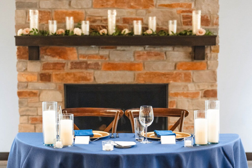 Sweetheart table by fireplace at The Bluffs at Conner Prairie wedding venue.