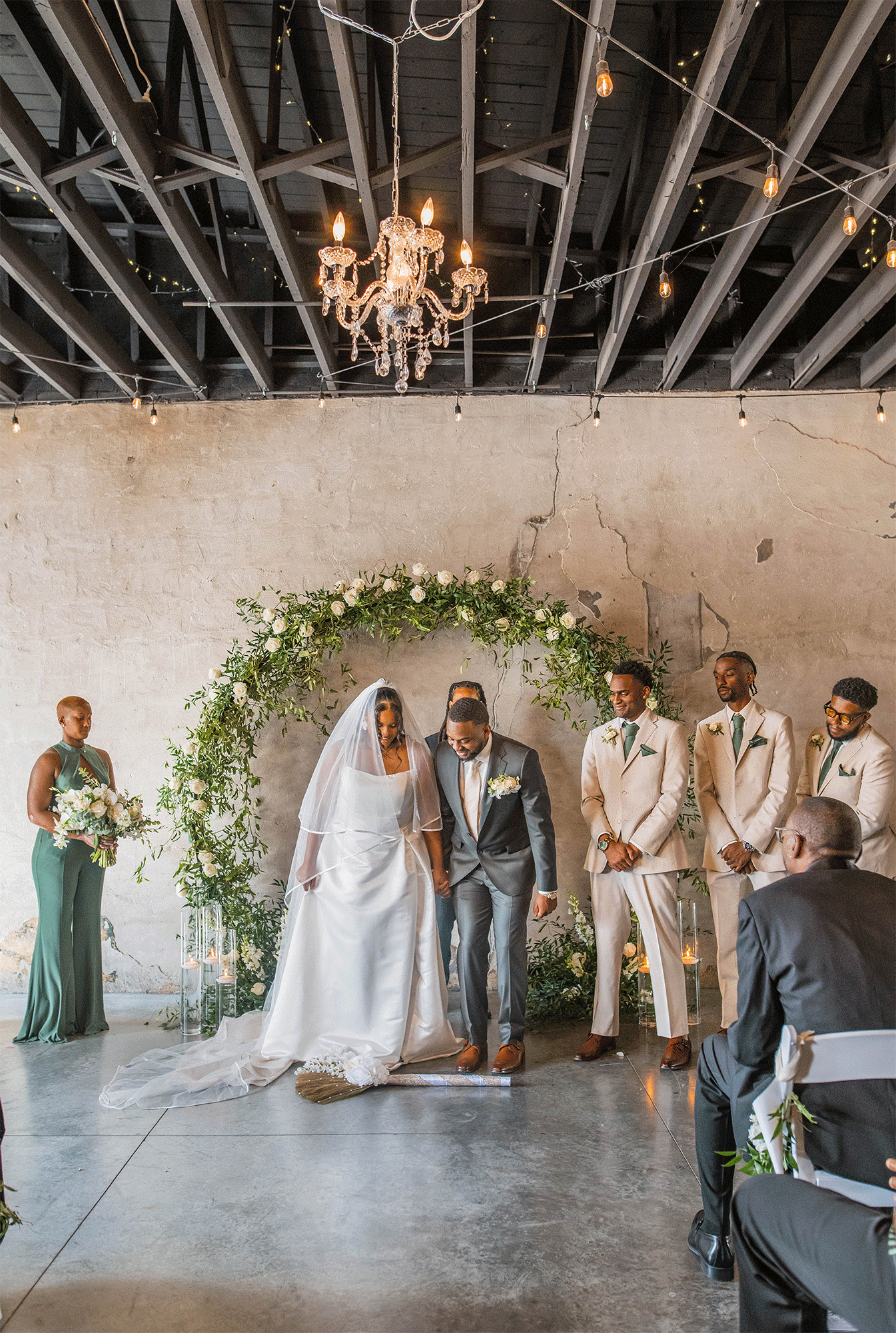 GIF of bride and groom jumping the broom during their indoor wedding ceremony at Ivory Foundry Weddings & Events.