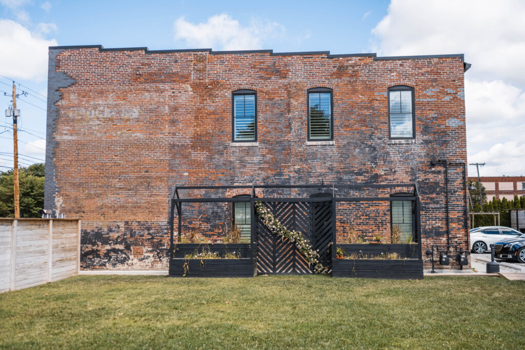 Brick building and outside ceremony space at Ivory Foundry.