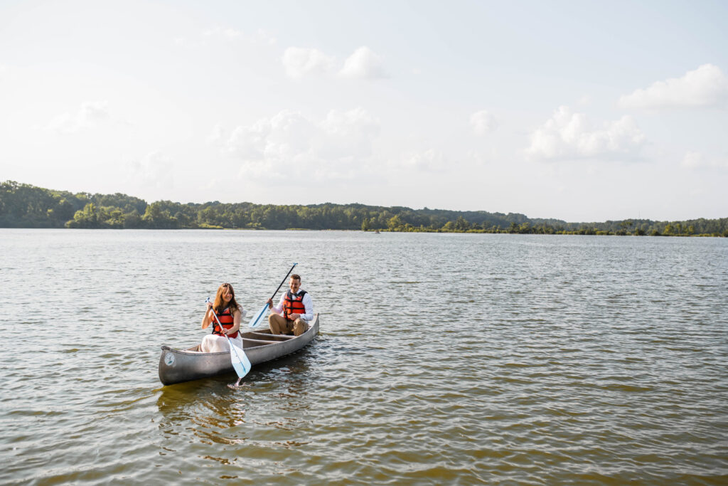 Bride and groom canoe during their outdoor elopement at Eagle Creek Park in Indianapolis.