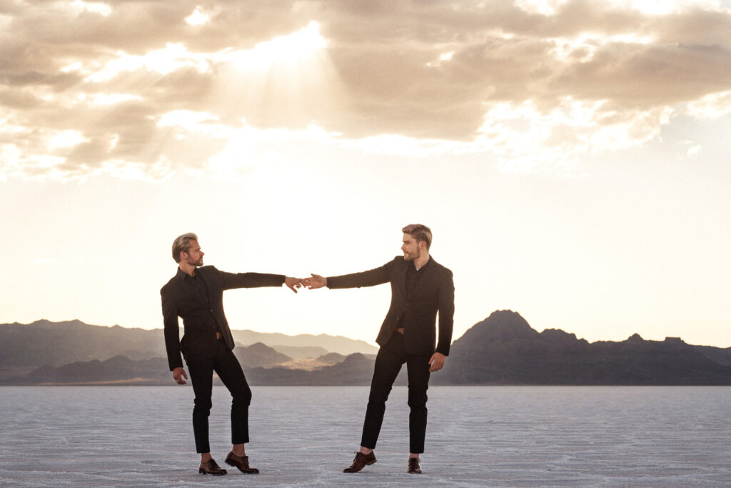 Two grooms have an outdoor elopement in the Salt Flats at sunset.