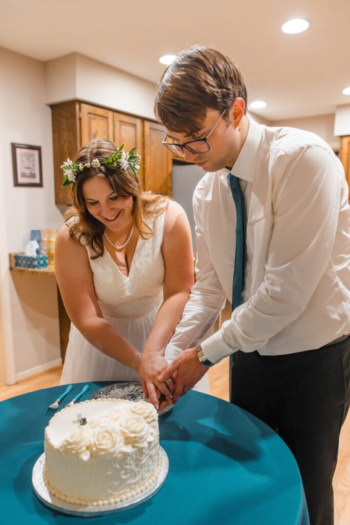 Couple cuts into their wedding cake during their Indiana micro wedding.