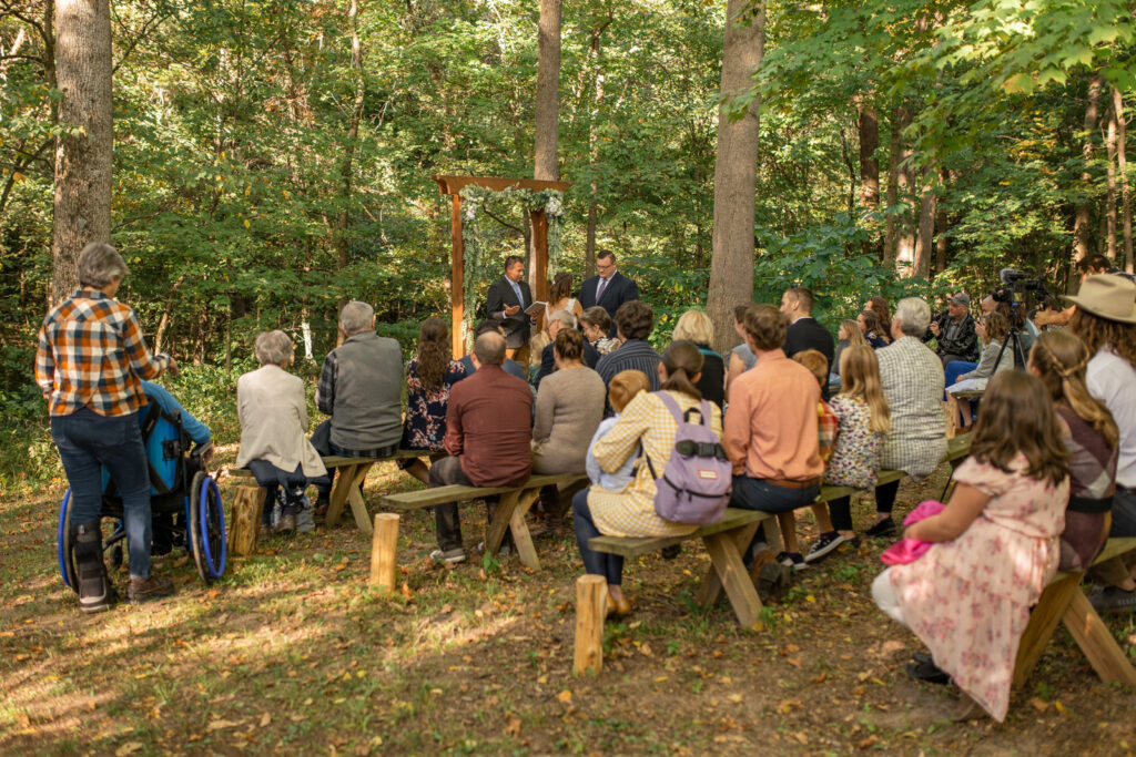 Guests gathered around couple during a woodsy micro wedding ceremony in Indiana.