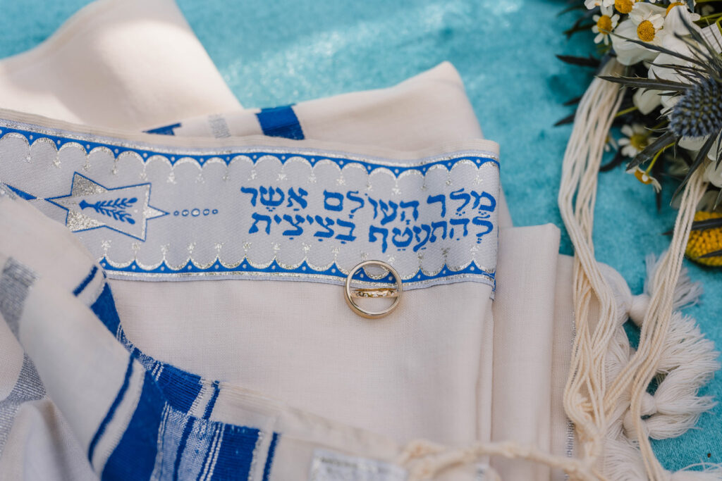 Wedding rings on tallit used during micro wedding ceremony.