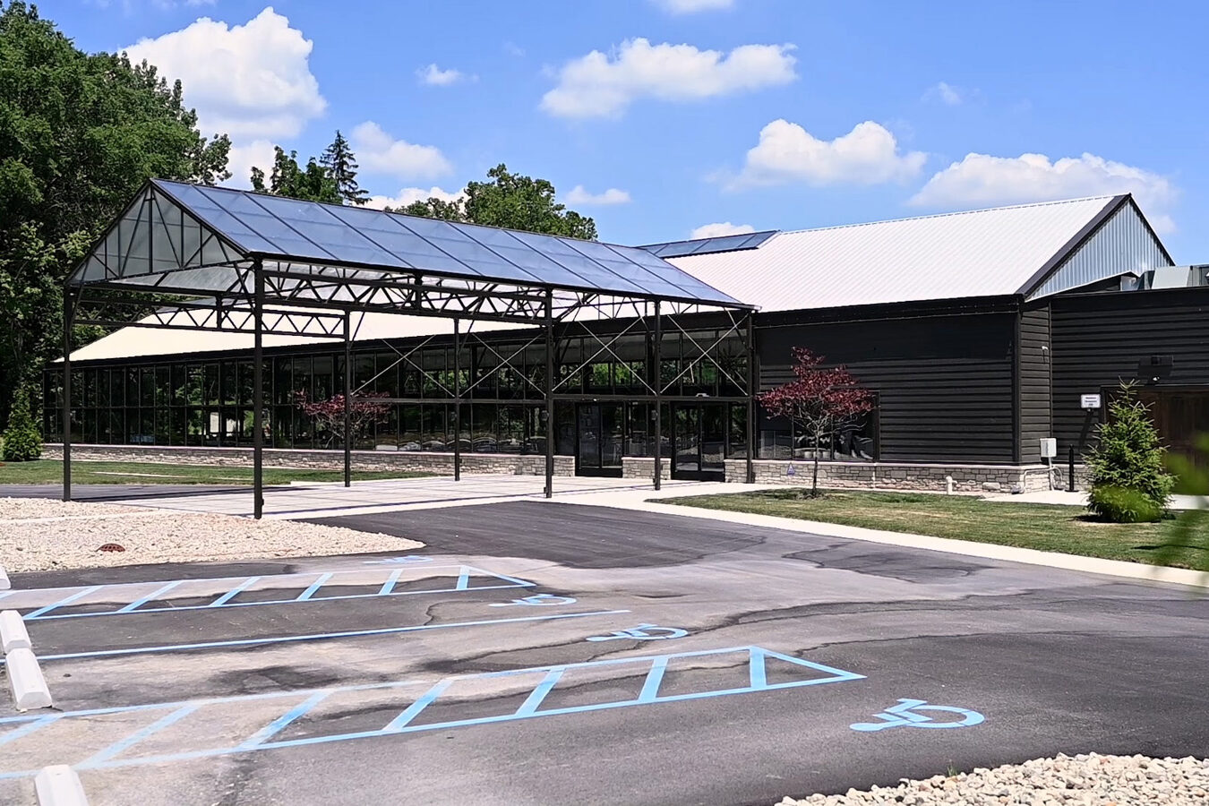 Glass structure at The Conservatory at Evergreen on sunny day.